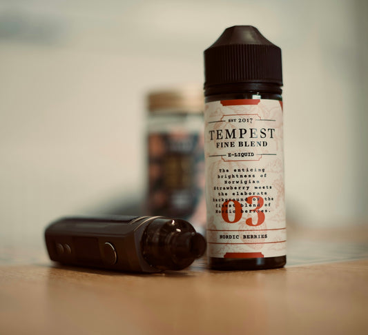 a bottle of e - liquid next to an electronic device