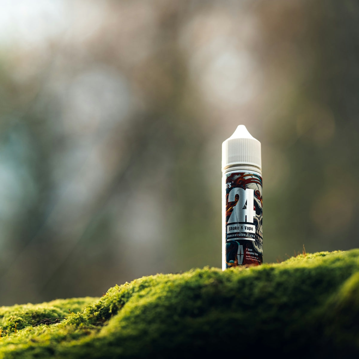 a bottle of e - liquid sitting on a mossy surface