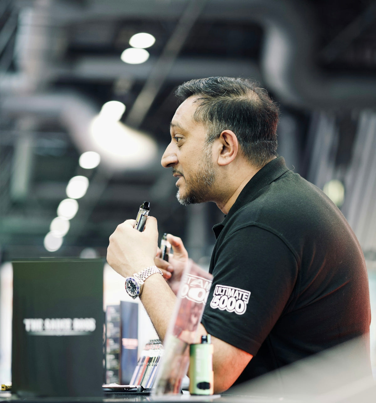 a man sitting at a table with a pen in his hand